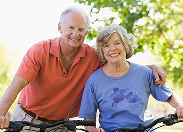 Photo of a man and woman on bicycles. Link to Life Stage Gift Planner Ages 60-70 Situations.